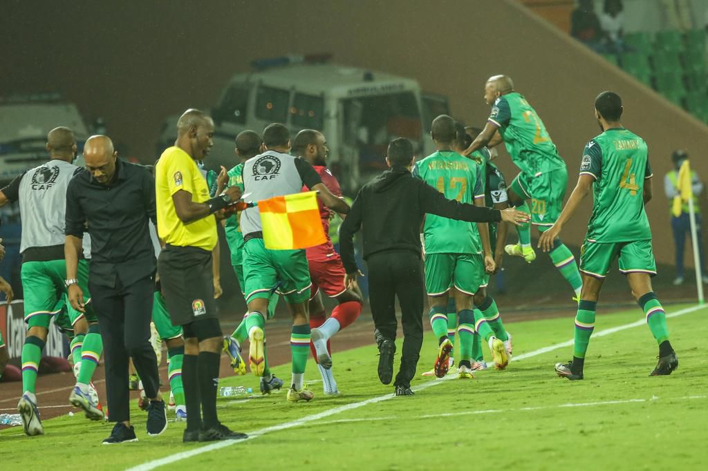 The Comoros team celebrates the late winner against Ghana with the bench and coaching staff