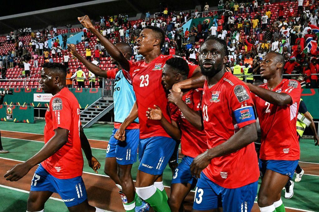 Gambia substitute Ablie Jallow (3R) celebrates with teammates after scoring the goal that beat Tunisia in an Africa Cup of Nations Group F match in Limbe on Thursday