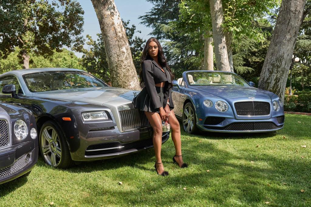 The supermodel poses with her fleet of cars