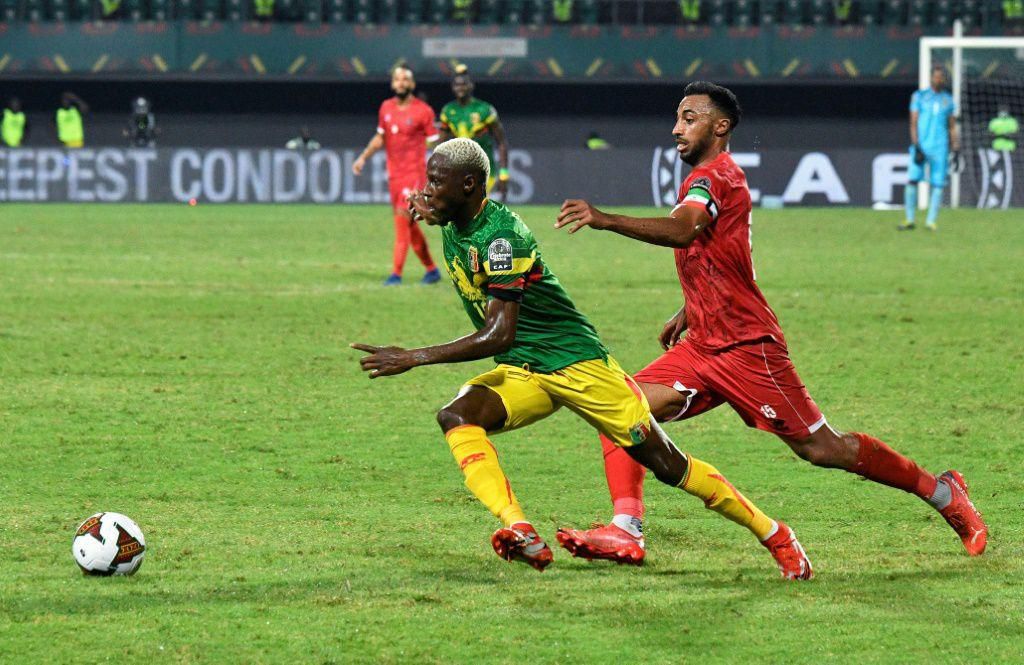 Mali winger Moussa Djenepo (L) is pursued by Equatorial Guinea captain and defender Carlos Akapo during an Africa Cup of Nations last-16 match in Limbe on Wednesday