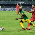 Mali winger Moussa Djenepo (L) is pursued by Equatorial Guinea captain and defender Carlos Akapo during an Africa Cup of Nations last-16 match in Limbe on Wednesday