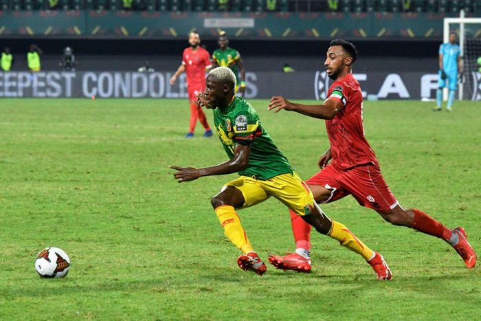 Mali winger Moussa Djenepo (L) is pursued by Equatorial Guinea captain and defender Carlos Akapo during an Africa Cup of Nations last-16 match in Limbe on Wednesday