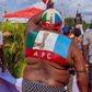 An APC party supporter waves the party's flag at an election campaign rally in Edo State [Twitter/@PastorIzeIyamu]