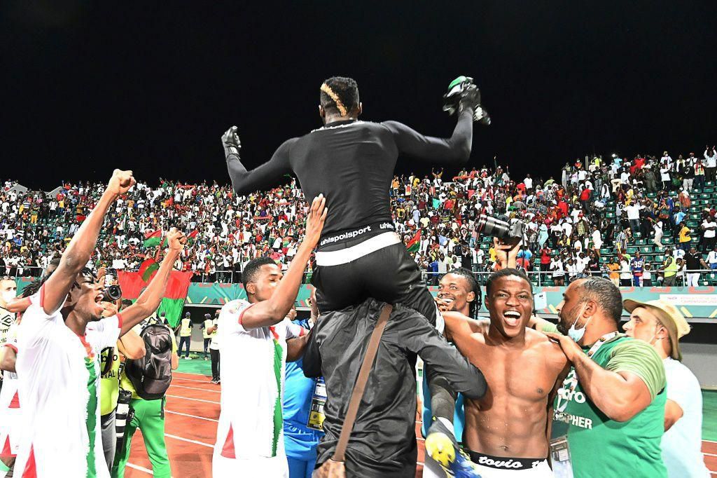 Burkina Faso goalkeeper Herve Koffi is hoisted high during his team's victory celebrations