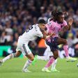 Alex Iwobi of Everton is challenged by Marc Roca of Leeds United during the Premier League match between Leeds United and Everton