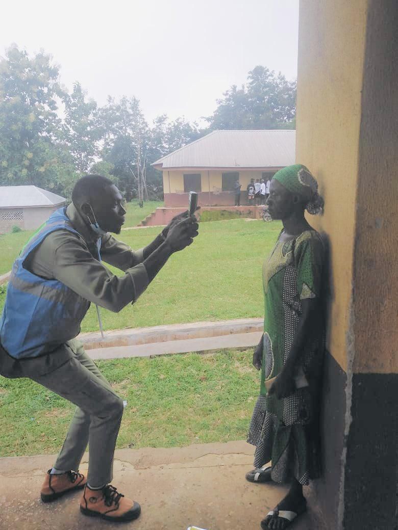 INEC official accredits voter with BVAS machine. [Twitter:INEC]