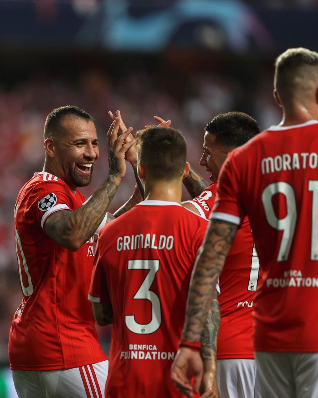 Nicolas Otamendi (smiling) celebrating with his teammates.