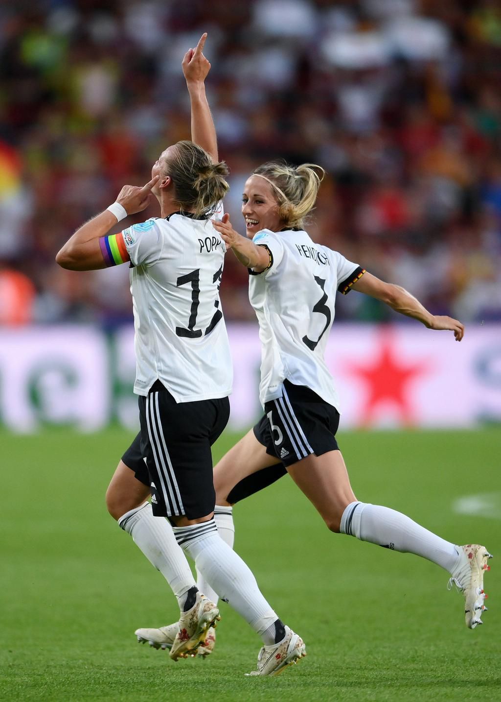 Popp celebrates with a teammate.