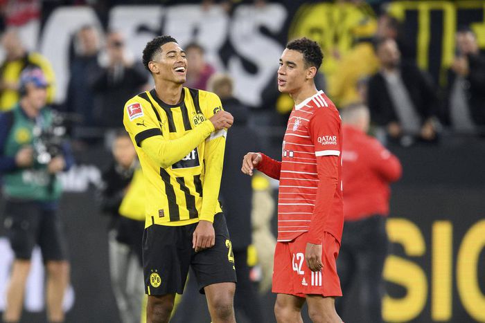 Jude Bellingham of Borussia Dortmund with Bayern Munich's Jamal Musiala during their Bundesliga match