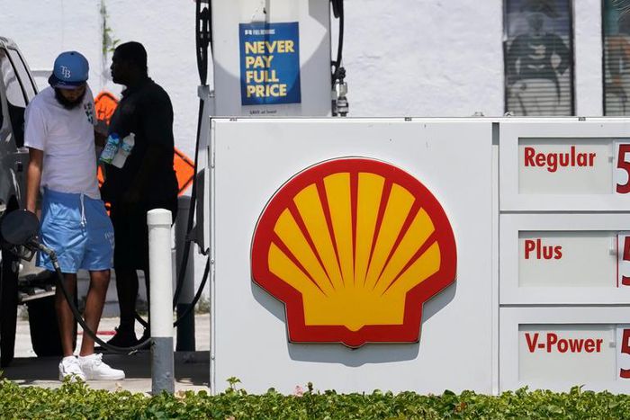 Consumers fill up at a Shell gas station July 13, 2022, in Miami Beach, Fla.