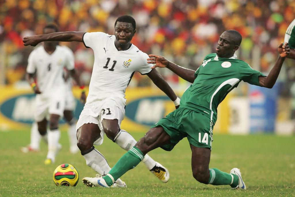 Sulley Muntari (L) and George Olofinjana (R) during the 2008 AFCON quarter-final game between Ghana and Nigeria
