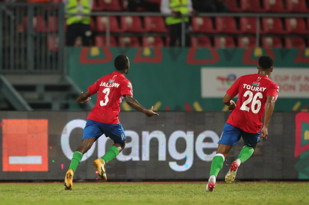 Gambia's hero, Ablie Jallow, wheels away after scoring the winner.