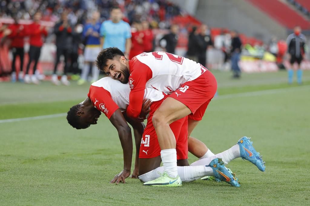 Umar celebrates his second goal with teammate Arnau Pigmal