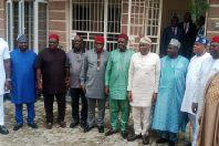 Group photograph of House of Reps. Minority Leader, Hon. Ndudi Elumelu and Daniel Bwala with other representatives of PDP Caucus in the House of Representatives in Abuja on Wednesday