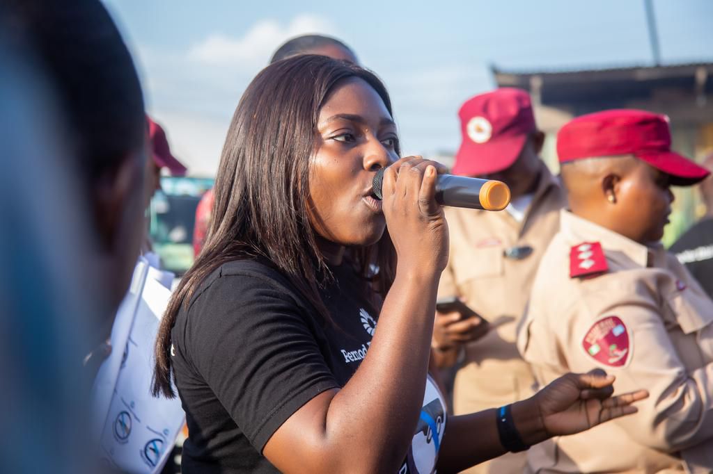 Nnenna Duru, Pernod Ricard Nigeria representative speaking to drivers and bystanders at the ECOMOG Interstate Park, Mile 2