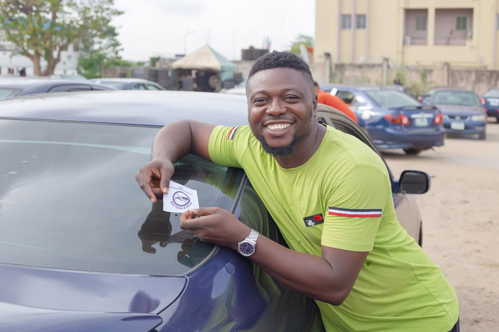An excited driver with the Pernod Ricard Nigeria’s “Don’t Drink and Drive” sticker at the International Airport Car Park, Ikeja