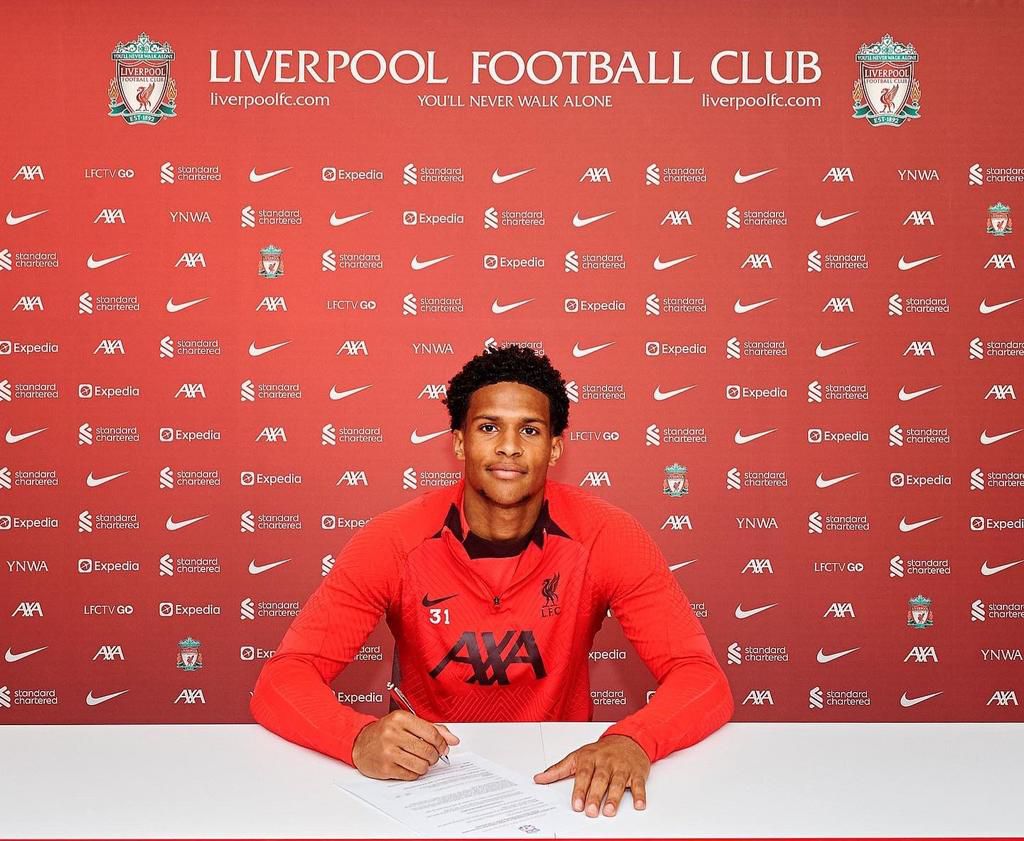 Oludare Olufunwa signs his new contract at Liverpool.