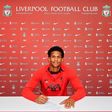 Oludare Olufunwa signs his new contract at Liverpool.
