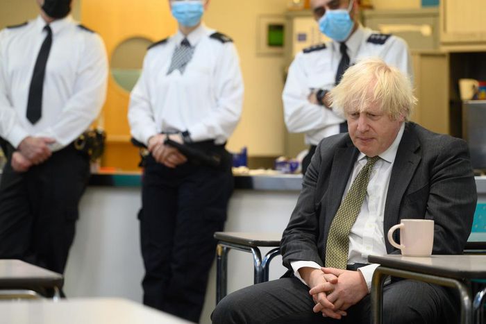 Prime Minster Boris Johnson speaks with members of the Metropolitan Police in their break room, as he makes a constituency visit to Uxbridge police station on December 17, 2021.