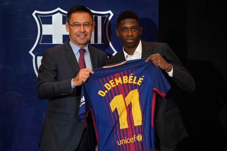 Barcelona's new player Ousmane Dembele (R) poses with his new jersey next to Barcelona's president Josep Maria Bartomeu at the Camp Nou stadium in Barcelona, during his official presentation at the Catalan football club, on August 28, 2017