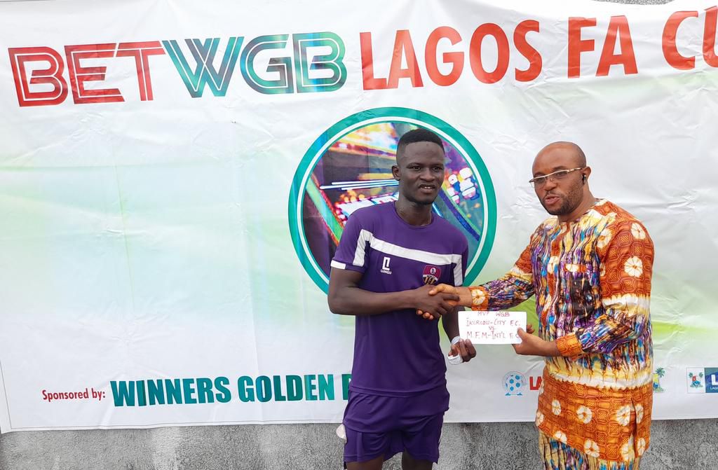 Muyiwa Alade receives his man of the match award.