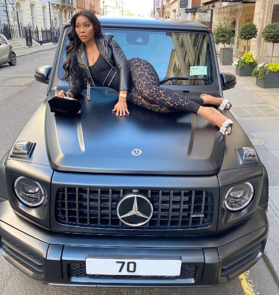 Kika good hair poses with her Mercedes Benz Brabus