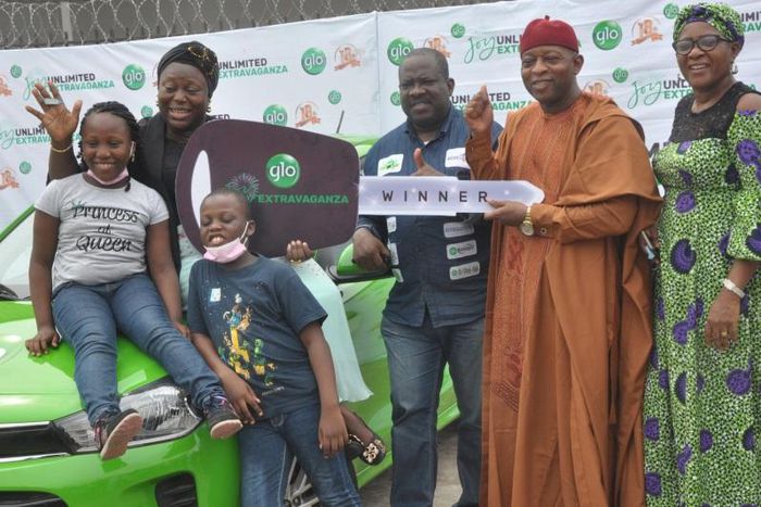 R-L: Zonal Coordinator, National Lottery Regulatory Commission, Lagos,  Mrs Priscilla Onuzulu, Hon. Jude Emeka Idimogu of the Lagos State House of Assembly;  Head, Enterprise Business Group, Globacom, Zakari Usman; winner of brand new car in Glo Joy Un...