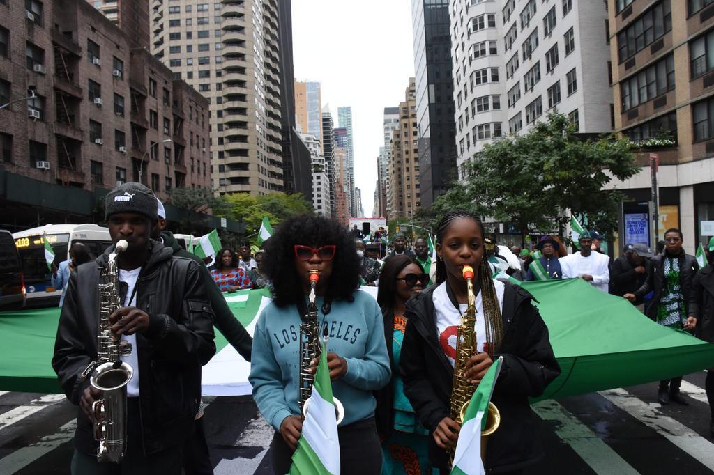 (Right) A Nigerian 12-year-old Saxophonist, Temilayo Abodunrin playing saxophone at the Independence Day Parade in New York on Saturday.