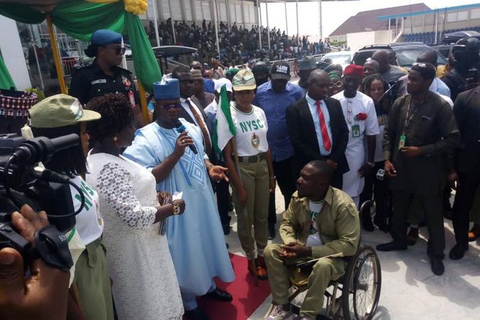 Gov. Yahaya Bello of Kogi, addressing youth corps member,Jemilu Akpah, physically challenged who got automatic employment on Thursday in Lokoja.