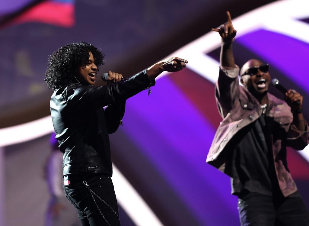 Davido (R) performs at the World Cup draw with Trinadad Cardona (L)