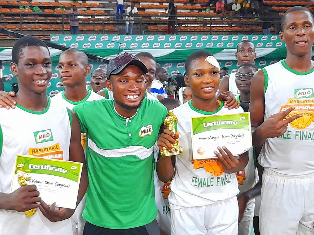 Valour Okini (L) and Abigail Isaac (second from R) with their MVP awards, flanked by a coach and teammate.