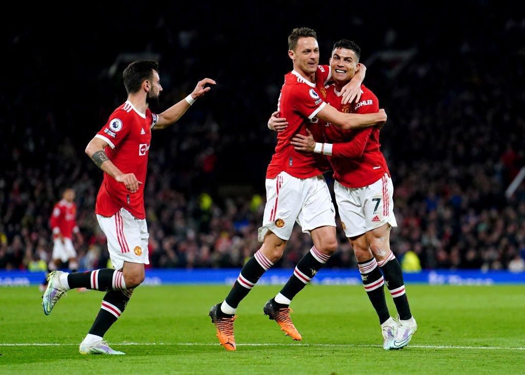 Manchester United's Cristiano Ronaldo (right) celebrates with his team-mates after scoring their side's first goal of the game during the Premier League match at Old Trafford, Manchester. Picture date: Thursday April 28, 2022. (Photo by Martin Rickett/...