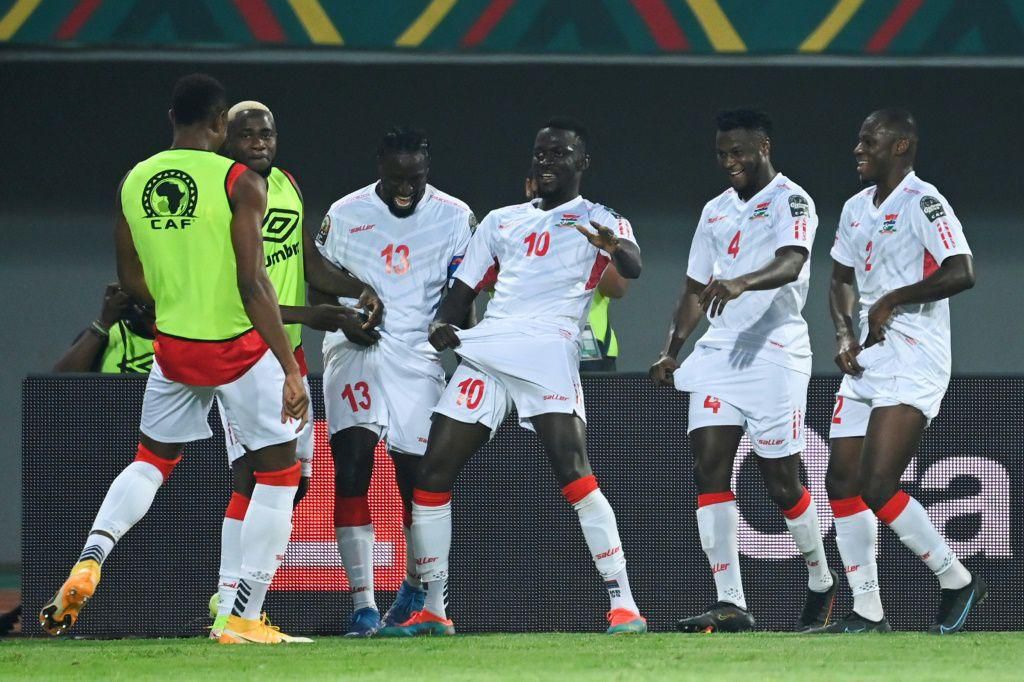 Musa Barrow (C) celebrates with his Gambia teammates after scoring against Guinea