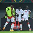 Musa Barrow (C) celebrates with his Gambia teammates after scoring against Guinea