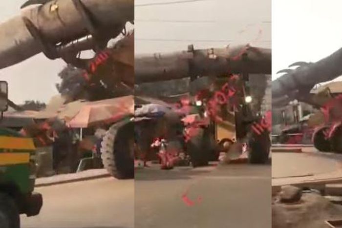 Buldozer carrying heavy log