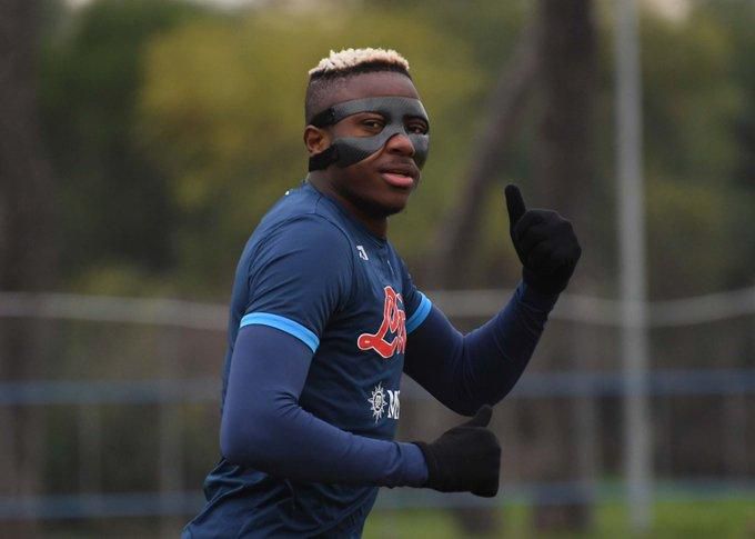 Osimhen spotted in Napoli training in a mask.