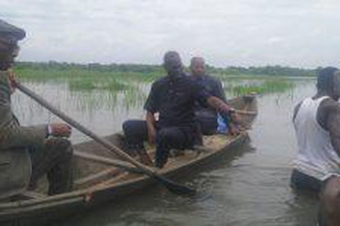 From Left, Delta Commissioner for Agriculture and Natural Resources, Dr Godfrey Enita (m) in a canoe  on Thursday while inspecting flooded rice farms at the Benin-Owena River Basin Authority in Ngegwu, Ajaji – Illah, Oshimili North Local Government Are...