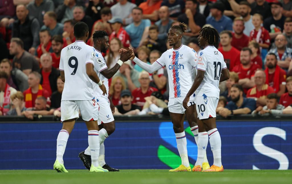 Wilfred Zaha celebrates with his teammates at Anfield.