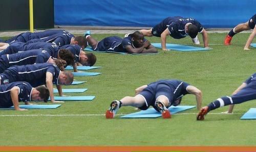 Balotelli casually observing the rest of his teammates during a training session