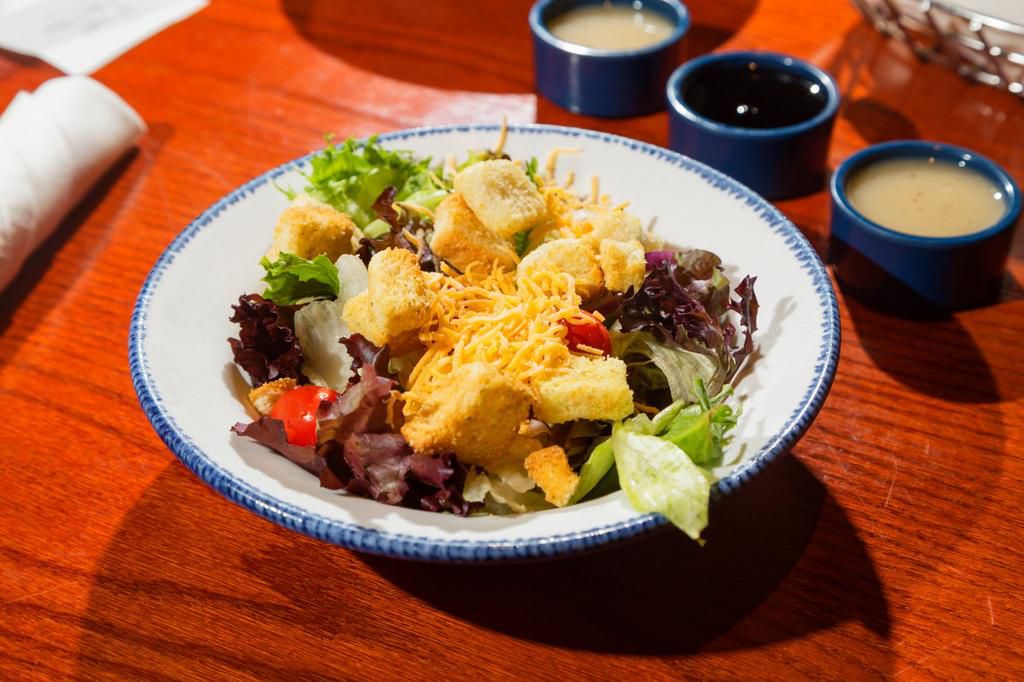 We got salad the way we know one must — simple, with Italian dressing on the side, a fittingly spartan start to the decadent and demanding feast.