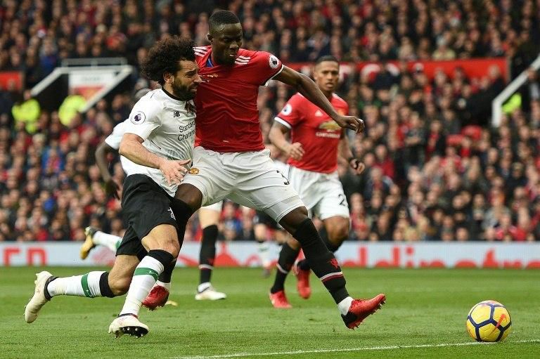 Mohamed Salah (L) vies with Eric Bailly during Liverpool's defeat against Manchester United at Old Trafford