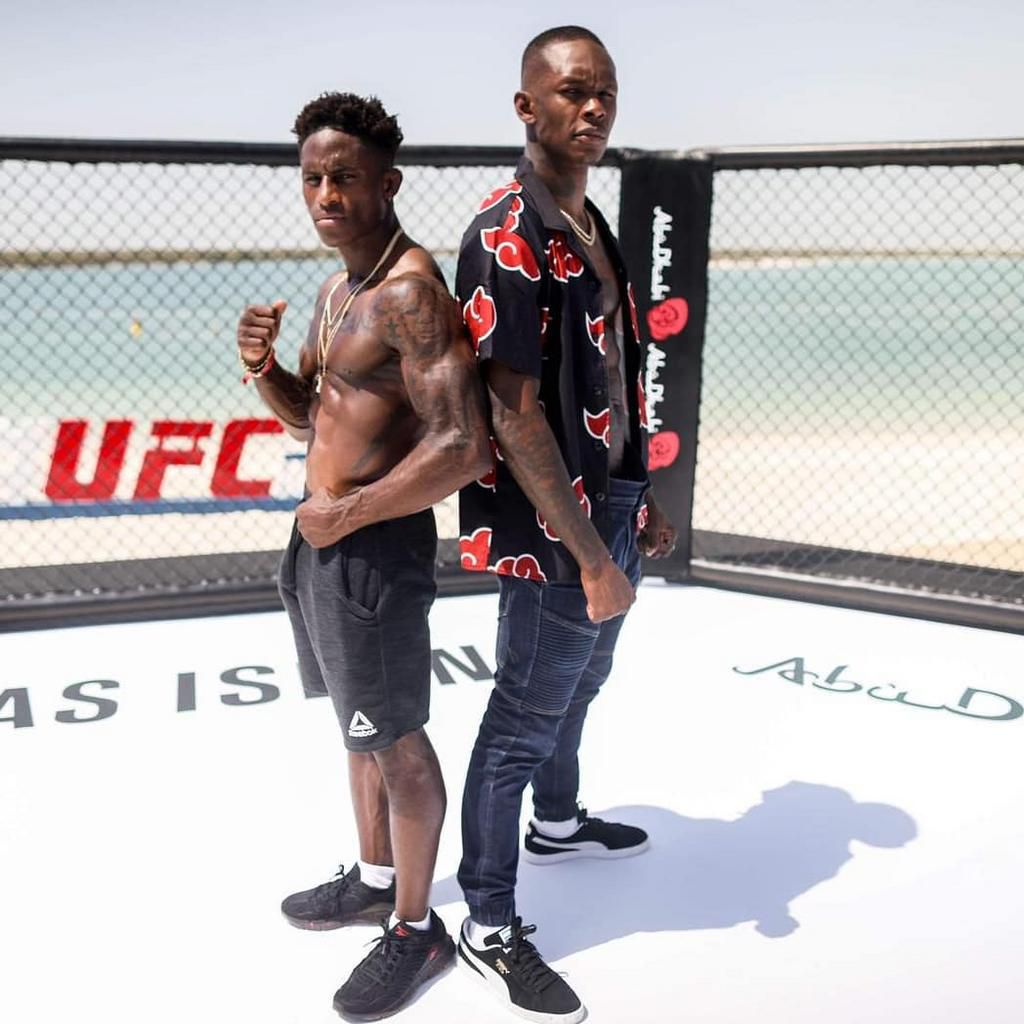 Dawodu posing alongside UFC Middleweight Champion Israel Adesanya