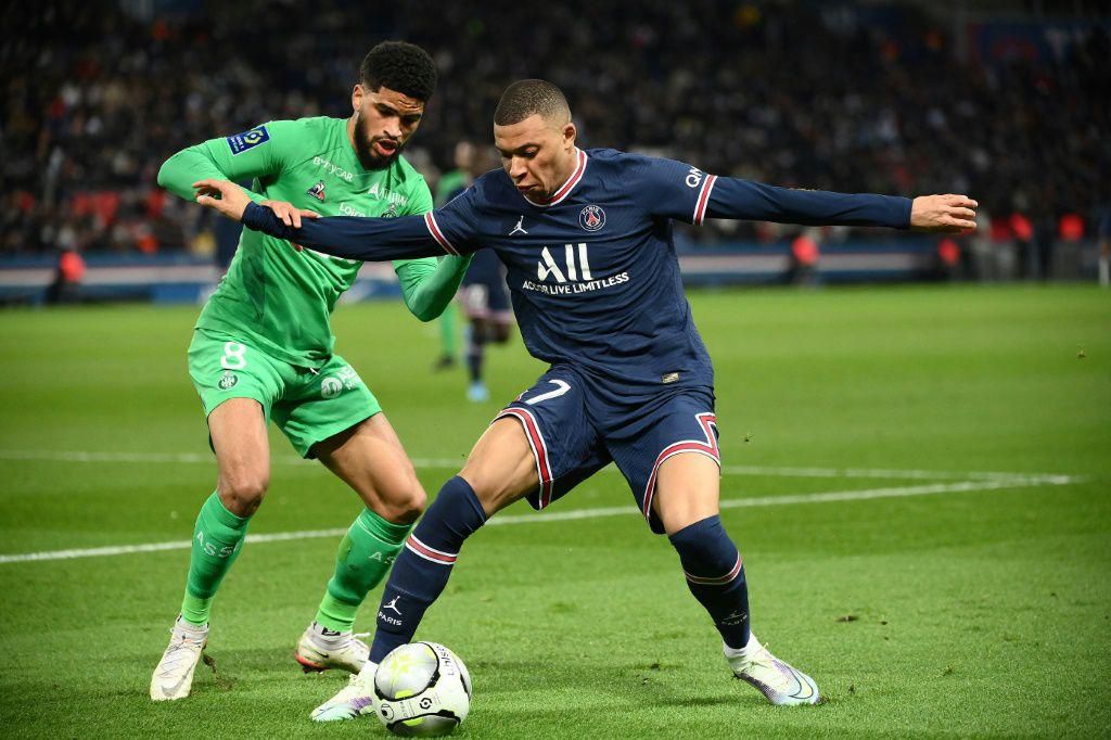 Kylian Mbappe holds off Mahdi Camara in PSG's 3-1 win over Saint-Etienne