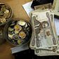Kenya shilling coins and notes are pictured inside a cashier's booth at a forex exchange bureau in Kenya's capital Nairobi, April 20, 2016. REUTERS/Thomas Mukoya