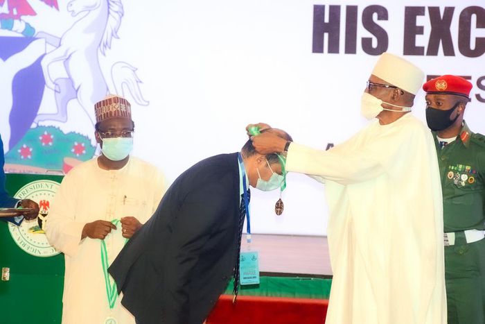 President Muhammadu Buhari presenting the 2022 National Productivity Award to Crown Flour Mill (CFM) Limited, represented by the Managing Director, Mr. Ashish Pande, during the 2022 National Productivity Order of Merit Award Ceremony held at the State ...