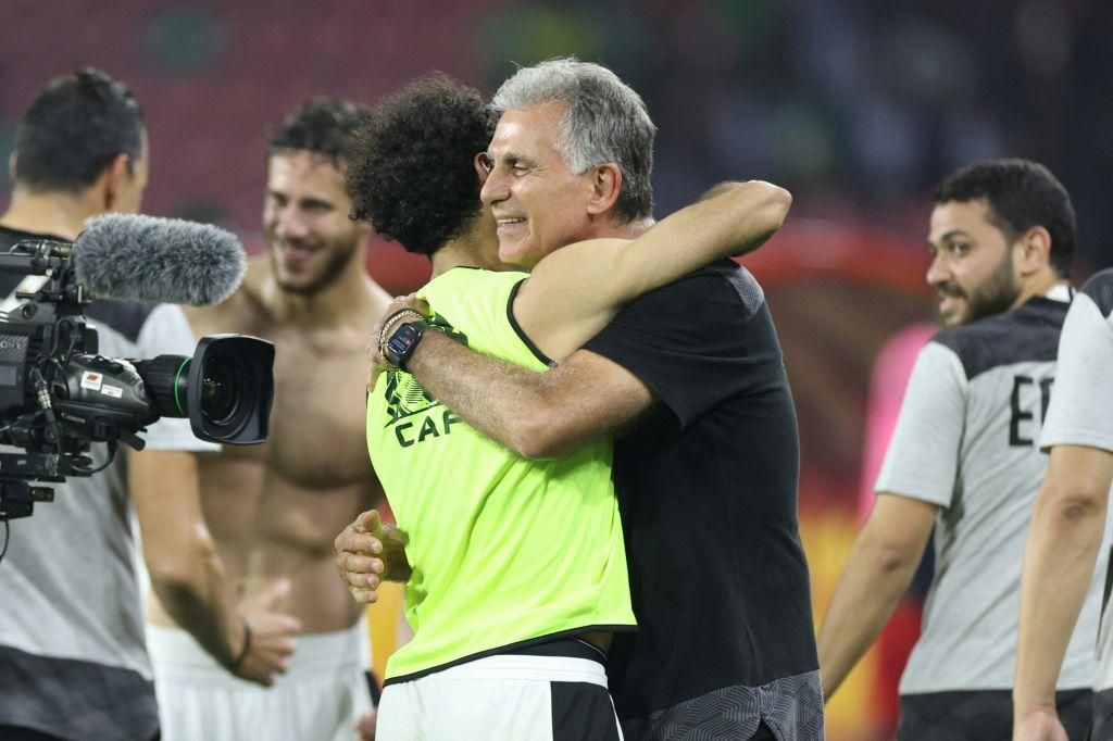 Egypt coach Carlos Queiroz celebrates with Mohamed Salah after their penalty shoot-out win over Cameroon