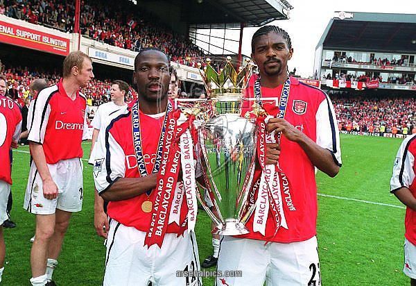Lauren (left) and Kanu lift the English Premiership Trophy. Arsenal trained-coaching staff will be joined by Lauren as they help talent identification skills among Kenyan coaches as the country targets participation in the World Cup 2022 to be held in ...