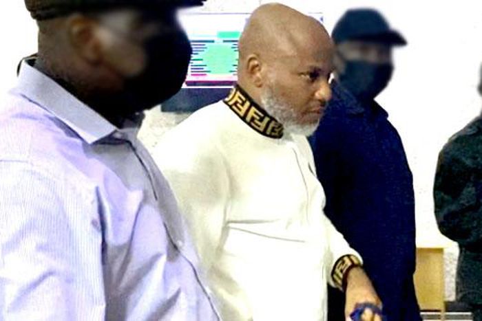 A file photo of Nnamdi Kanu (second left) at the court in Abuja. (Kola Sulaimon/AFP).