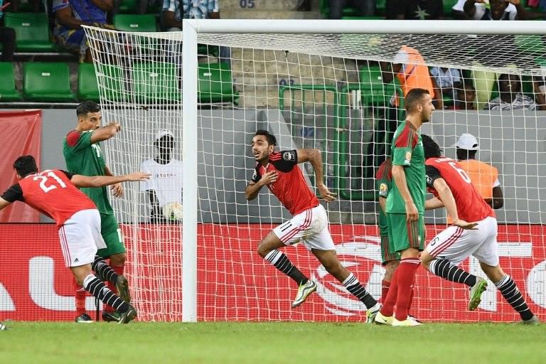 Egypt's midfielder Mahmoud Kahraba (C) celebrates with teammates after scoring a goal during the 2017 Africa Cup of Nations quarter-final football match between Egypt and Morocco in Port-Gentil on January 29, 2017