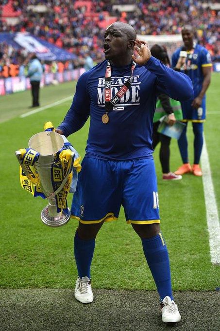 Akinfenwa holding the League two playoff trophy